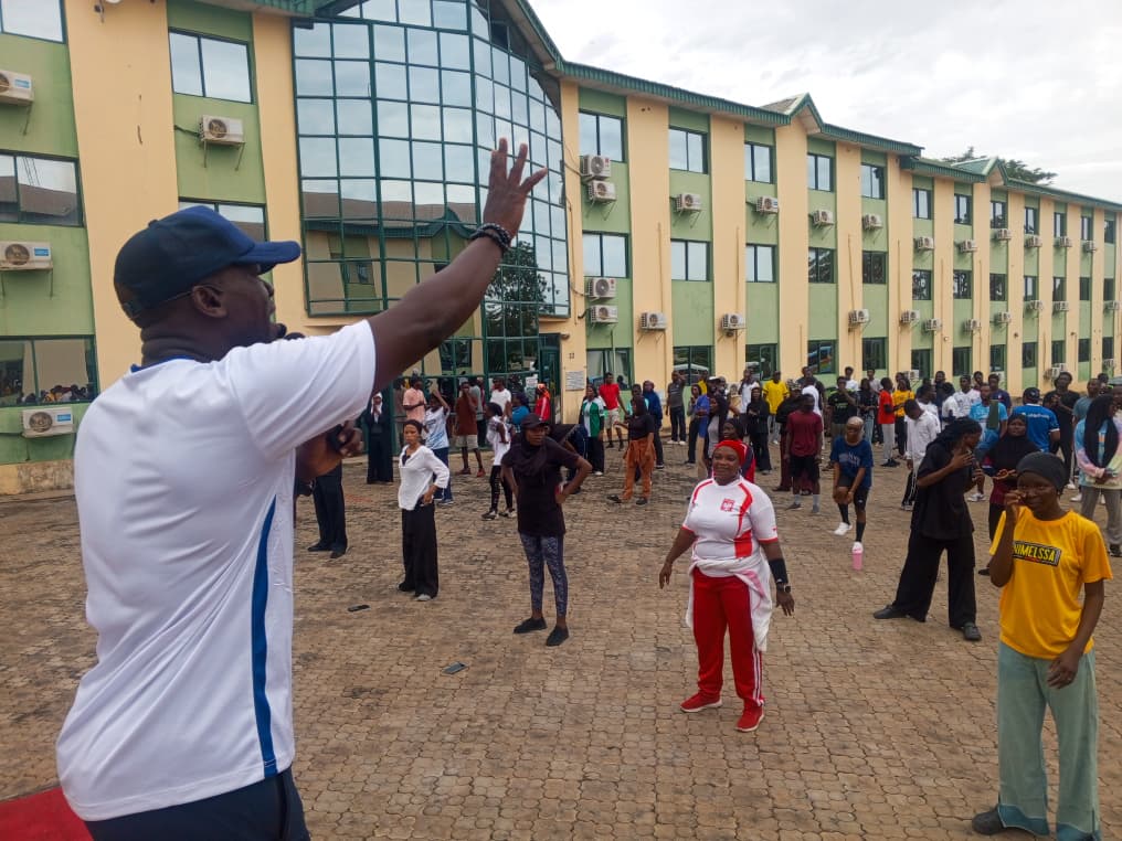 Coach Korede addressing participants during a community fitness programme