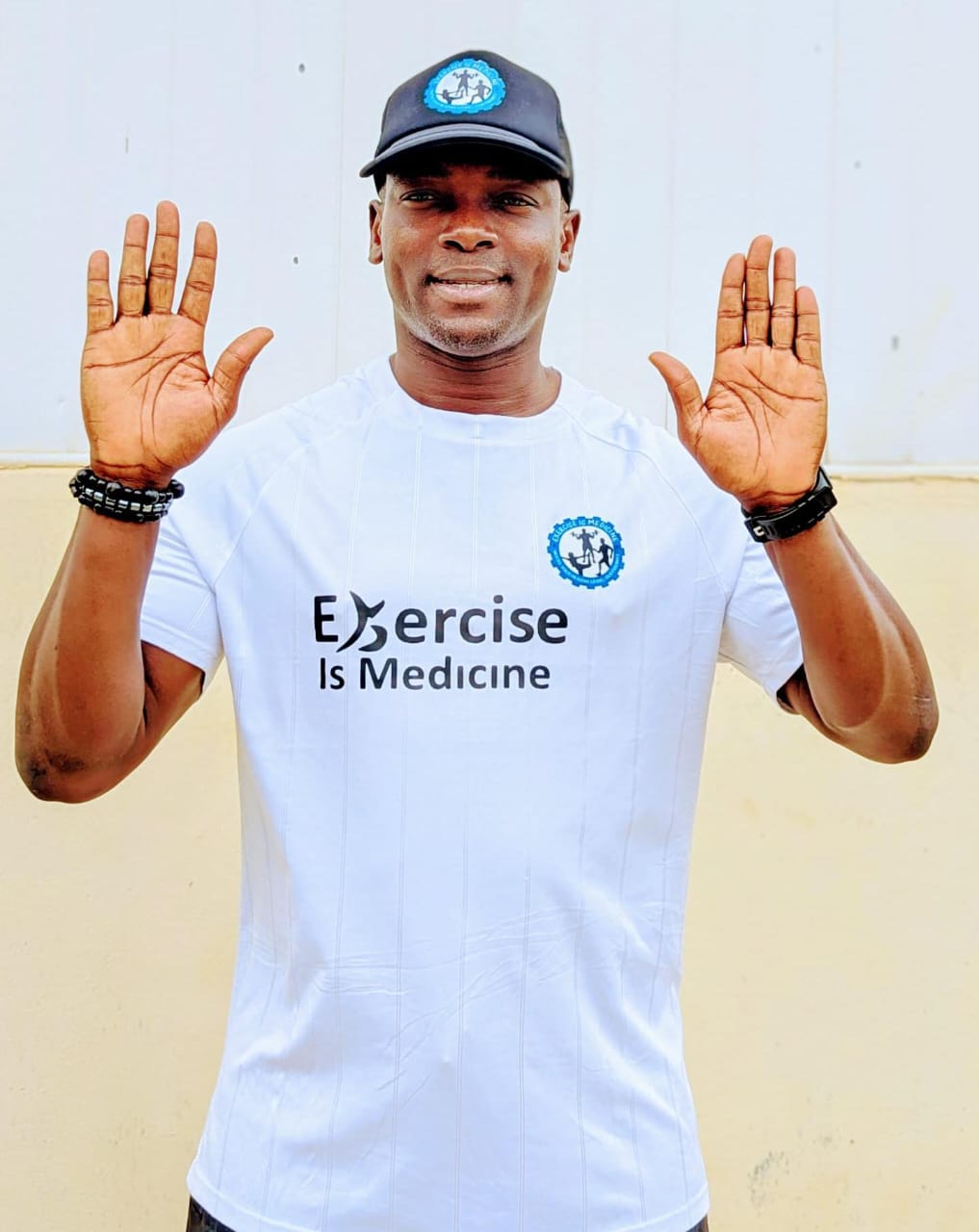Coach Korede wearing an Exercise Is Medicine shirt
