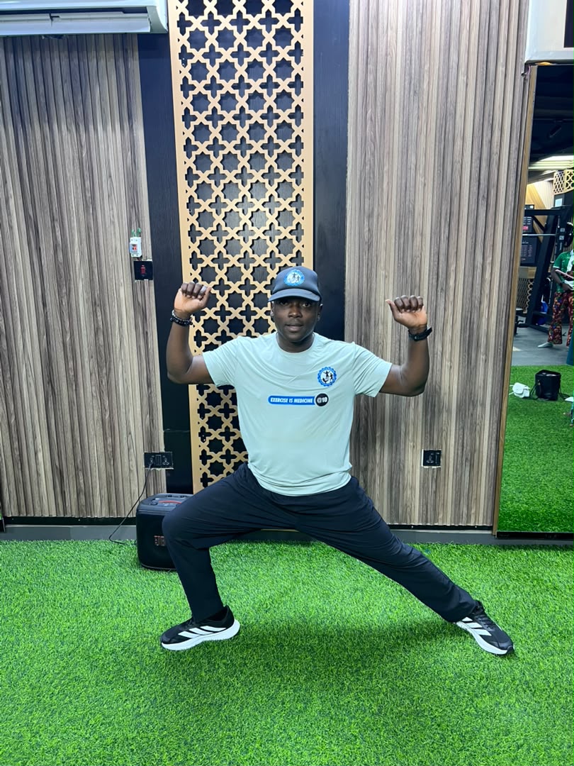 Coach Korede seated during a guided wellness session