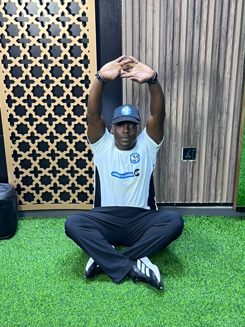 Coach Korede demonstrating a wide lateral fitness stance